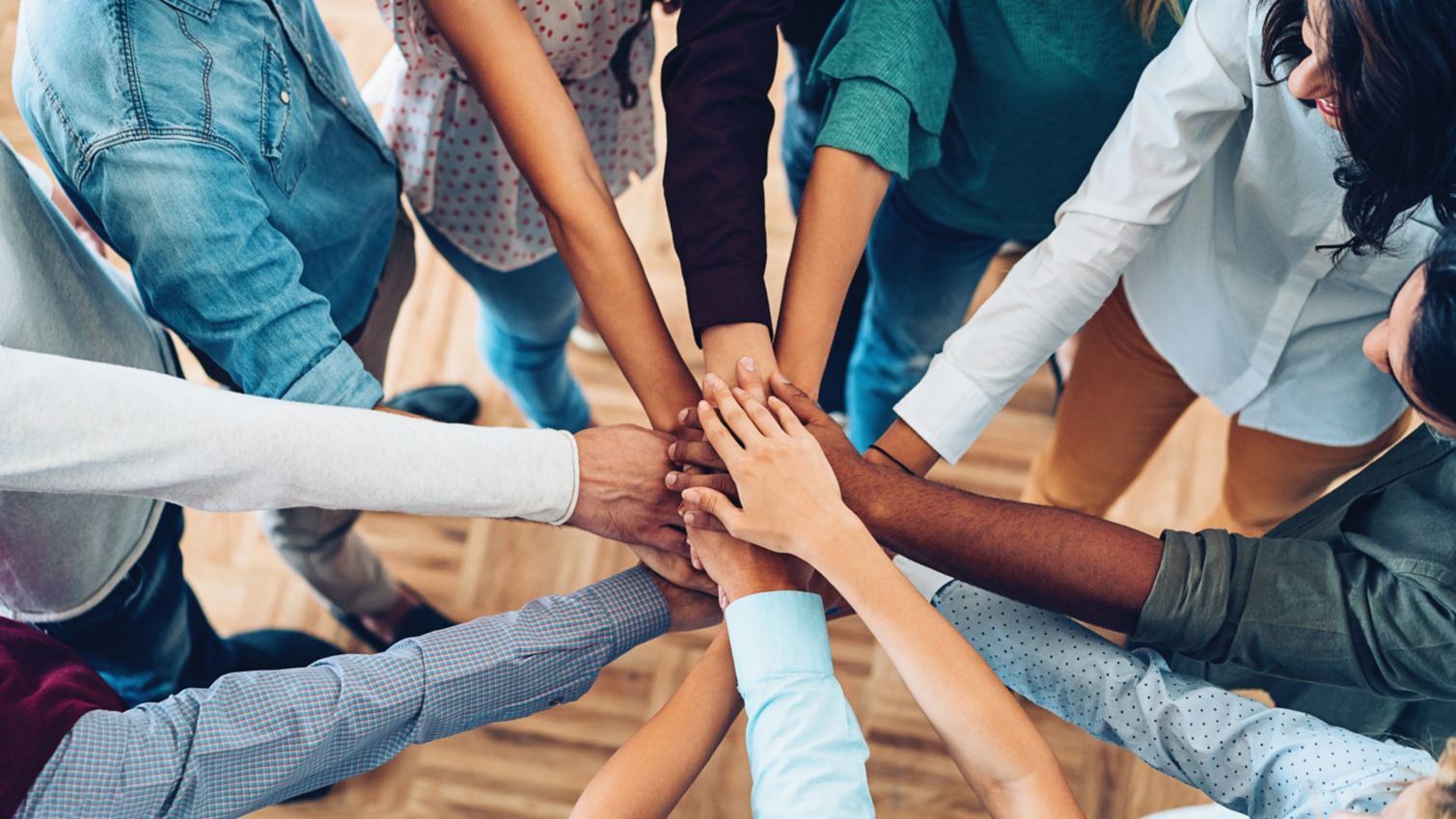 Volunteers put their hands together